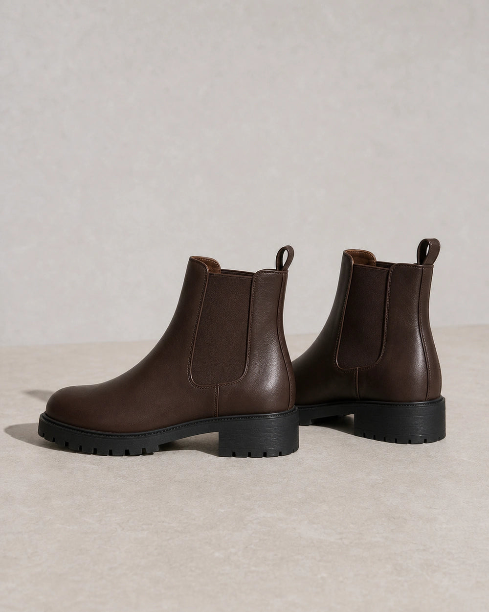 Women's chocolate brown lug-sole Chelsea boots, product-only view.