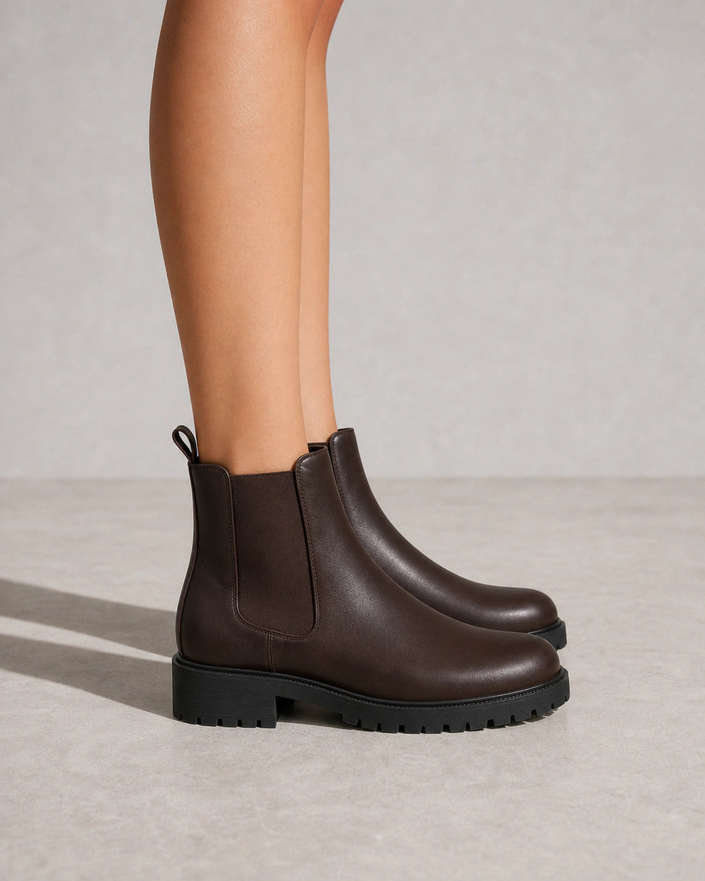 Women's chocolate brown lug-sole Chelsea boots, lateral profile.