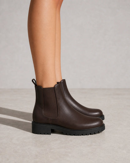 Women's chocolate brown lug-sole Chelsea boots, lateral profile.