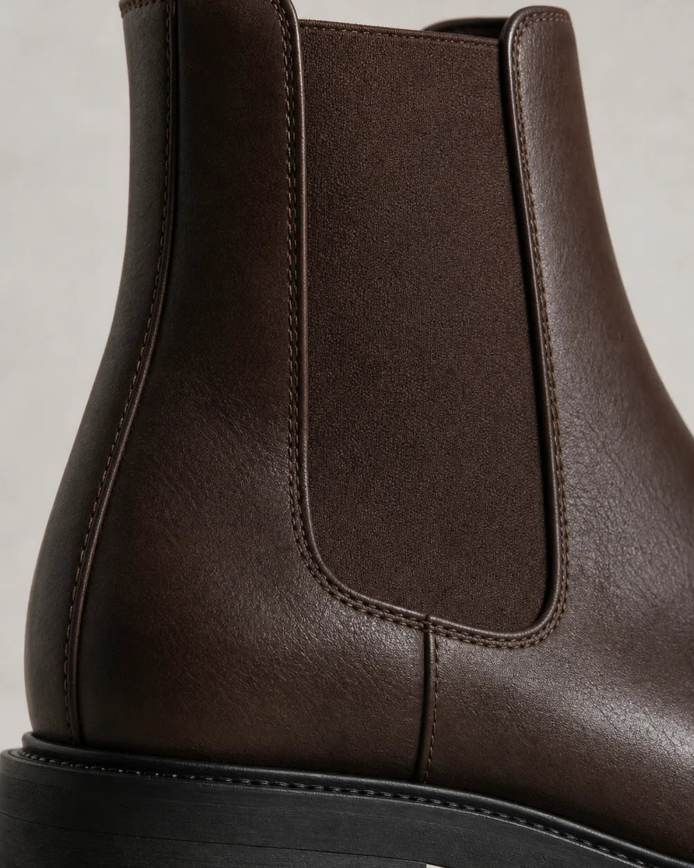 Women's chocolate brown lug-sole Chelsea boots, construction detail.
